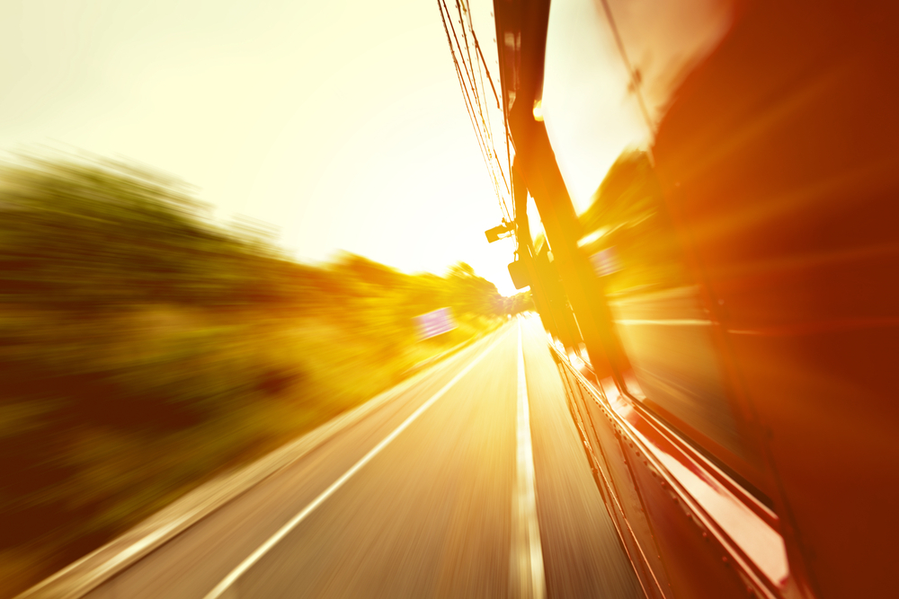Red old bus going fast on the highway with motion blur background